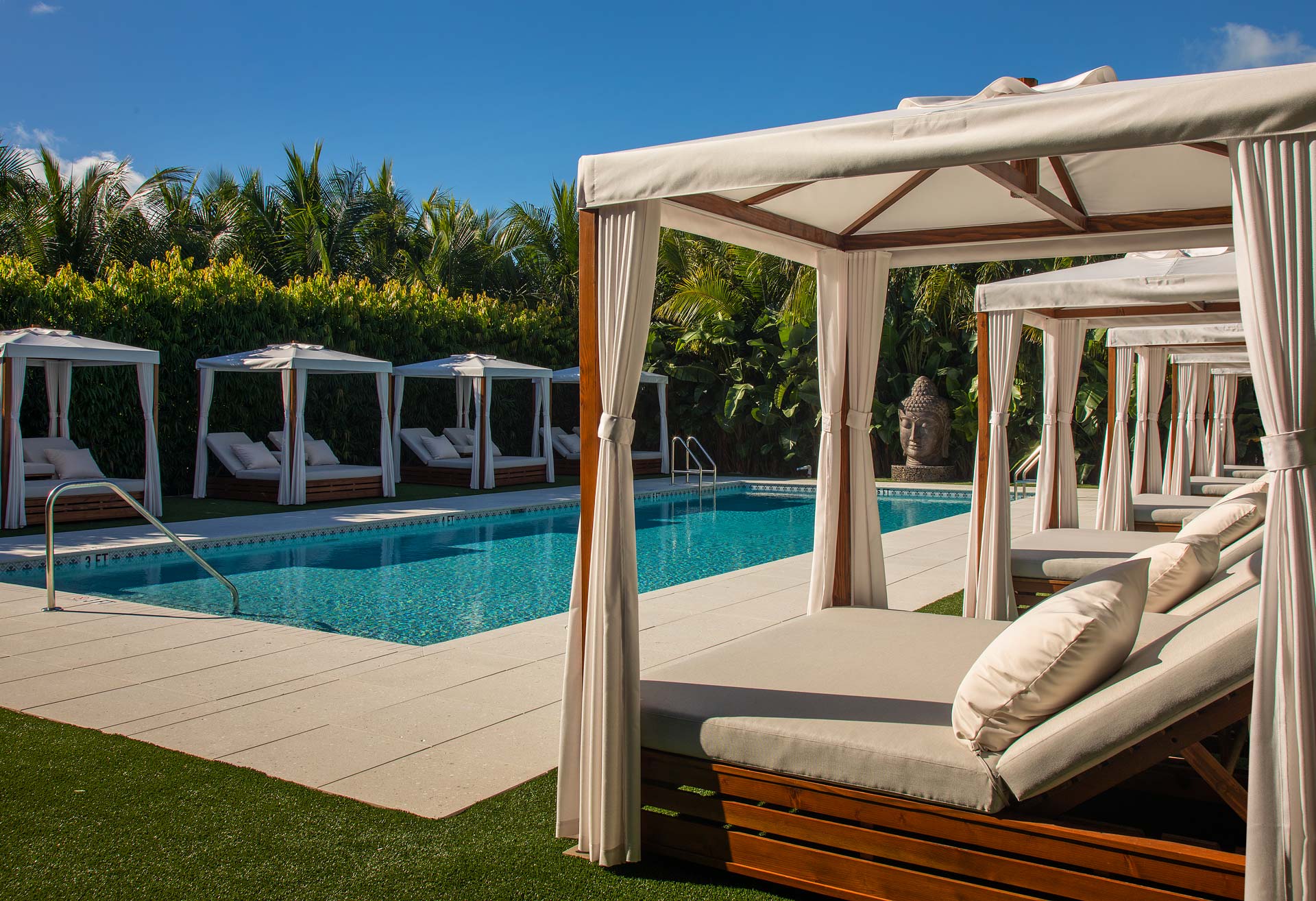 pool with eight cabana lounges surrounding it