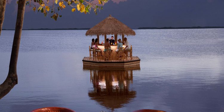 floating tiki bar at night in the water
