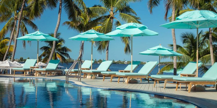 pool and patio area with light blue shade umbrellas