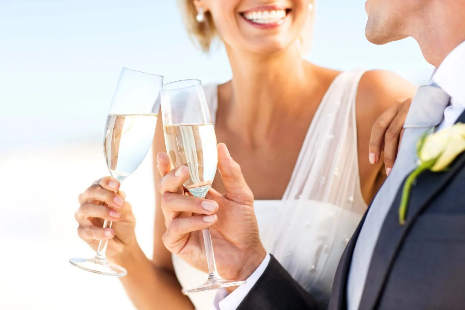 bride and groom drinking champagne together