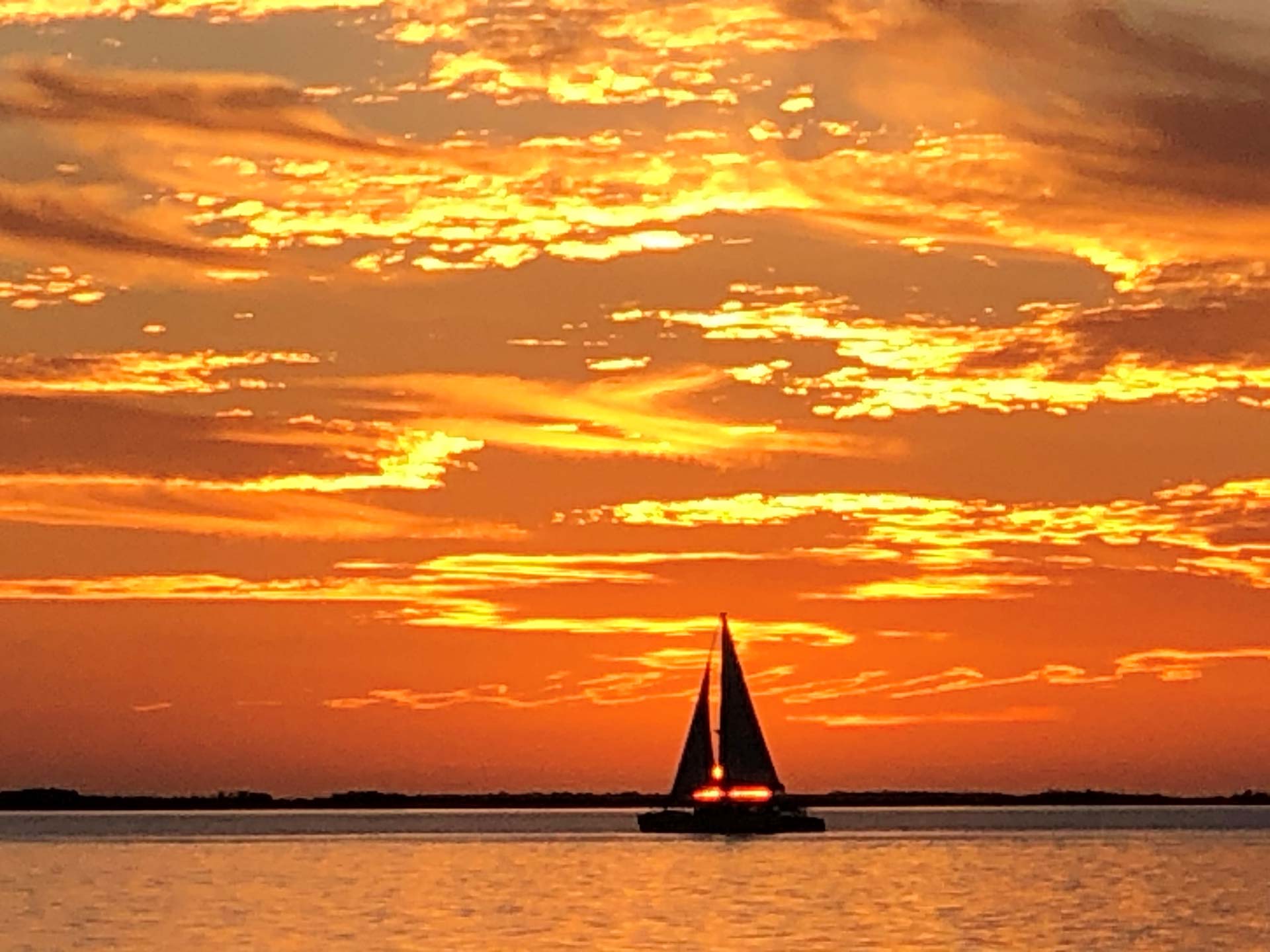 sailboat on the ocean at sunset