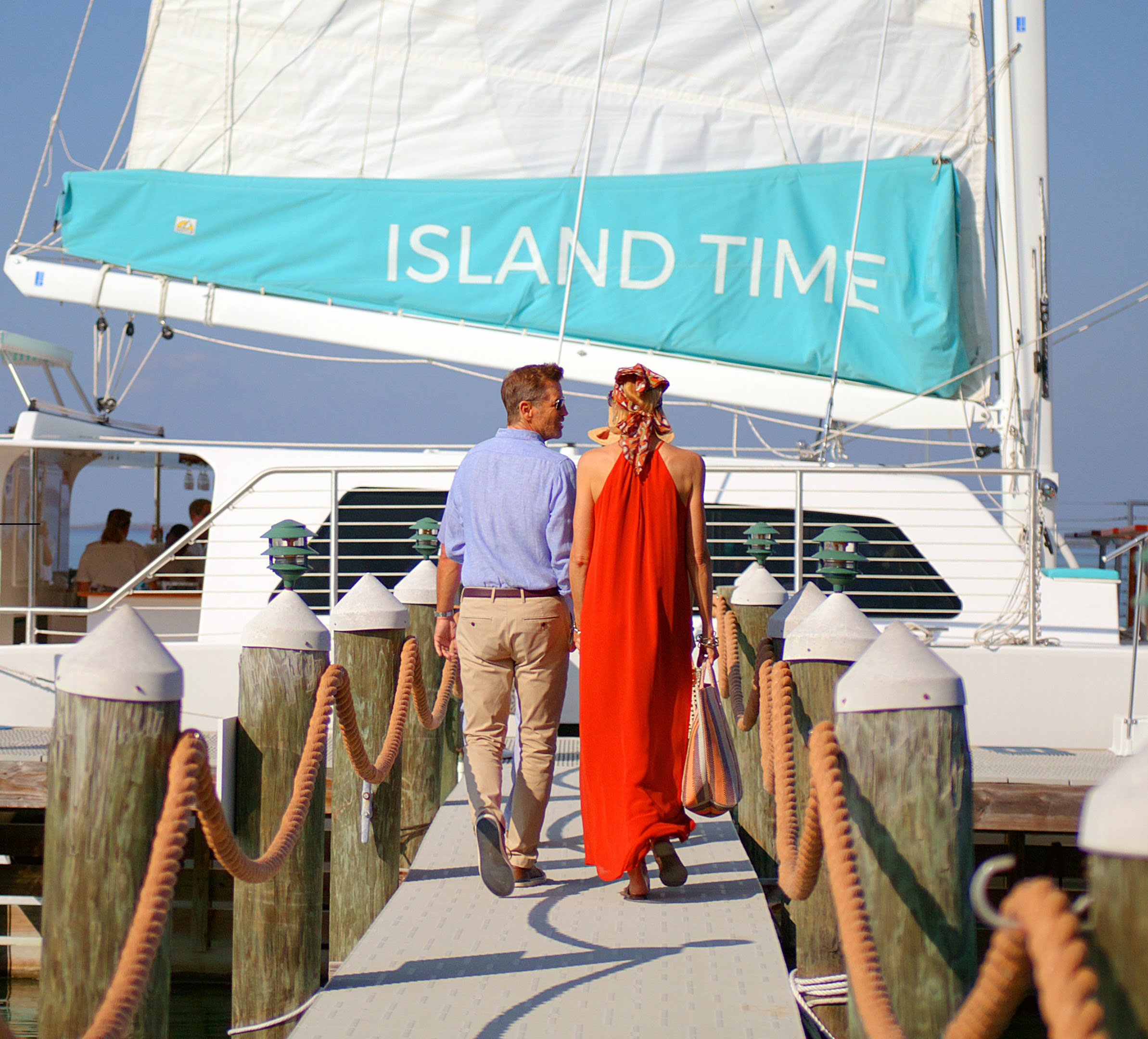 couple walking to a boat on the dock