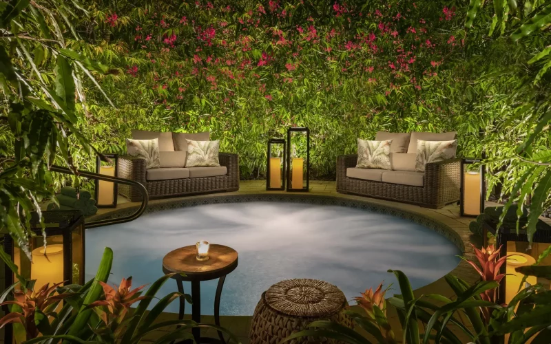 Zen pool at Bungalows Key Largo with love seats surrounded by plants and flowers