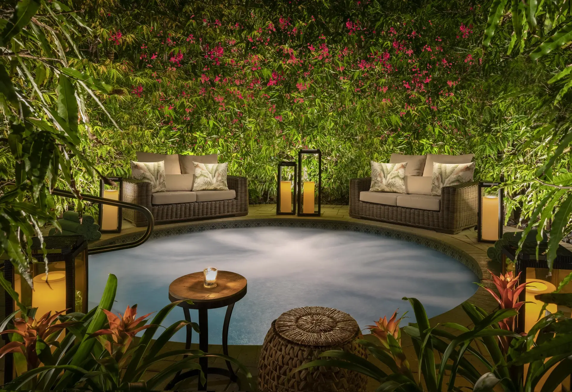 Zen pool at Bungalows Key Largo with love seats surrounded by plants and flowers