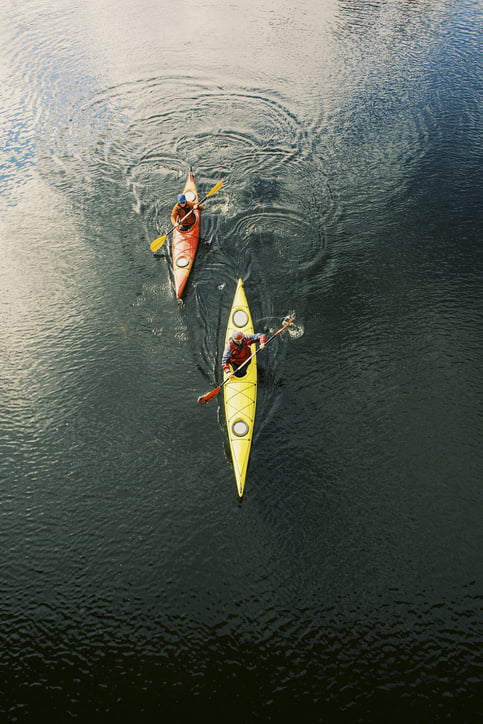 two men kayaking on a river
